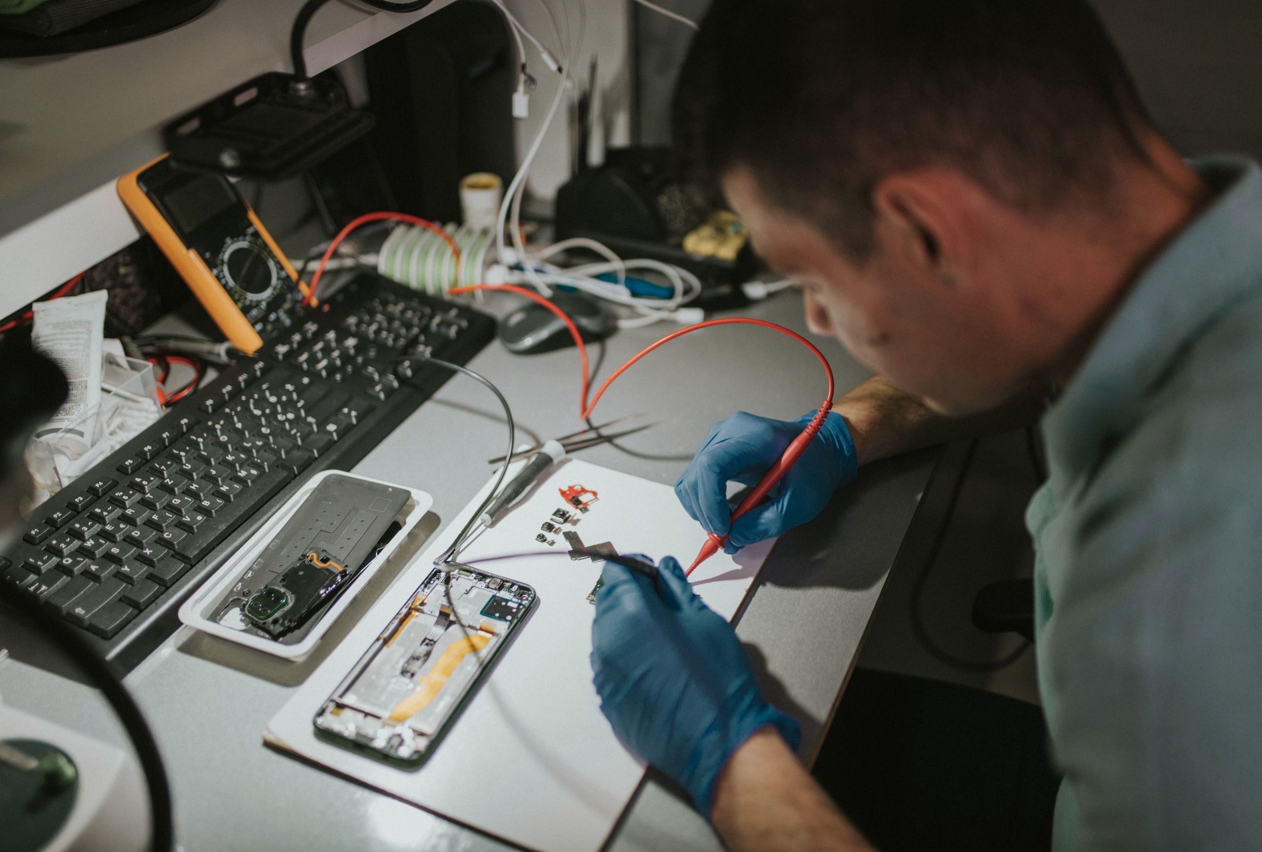 Technician servicing a laptop at Hi-Link Computer repair workshop in Dharan